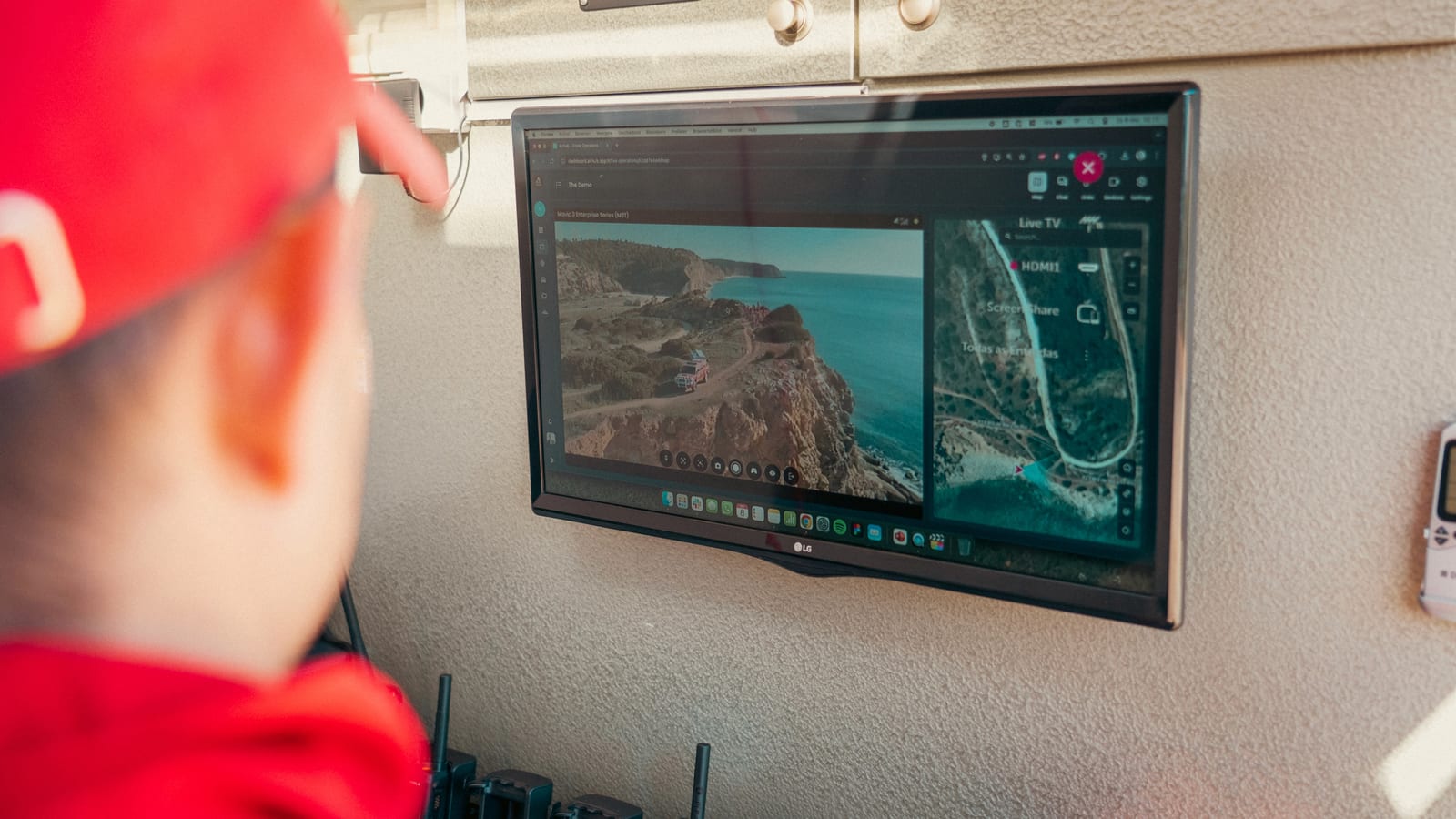 A Portuguese Bombeiros commander watching an AirHub live operations feed on a screen inside a command vehicle