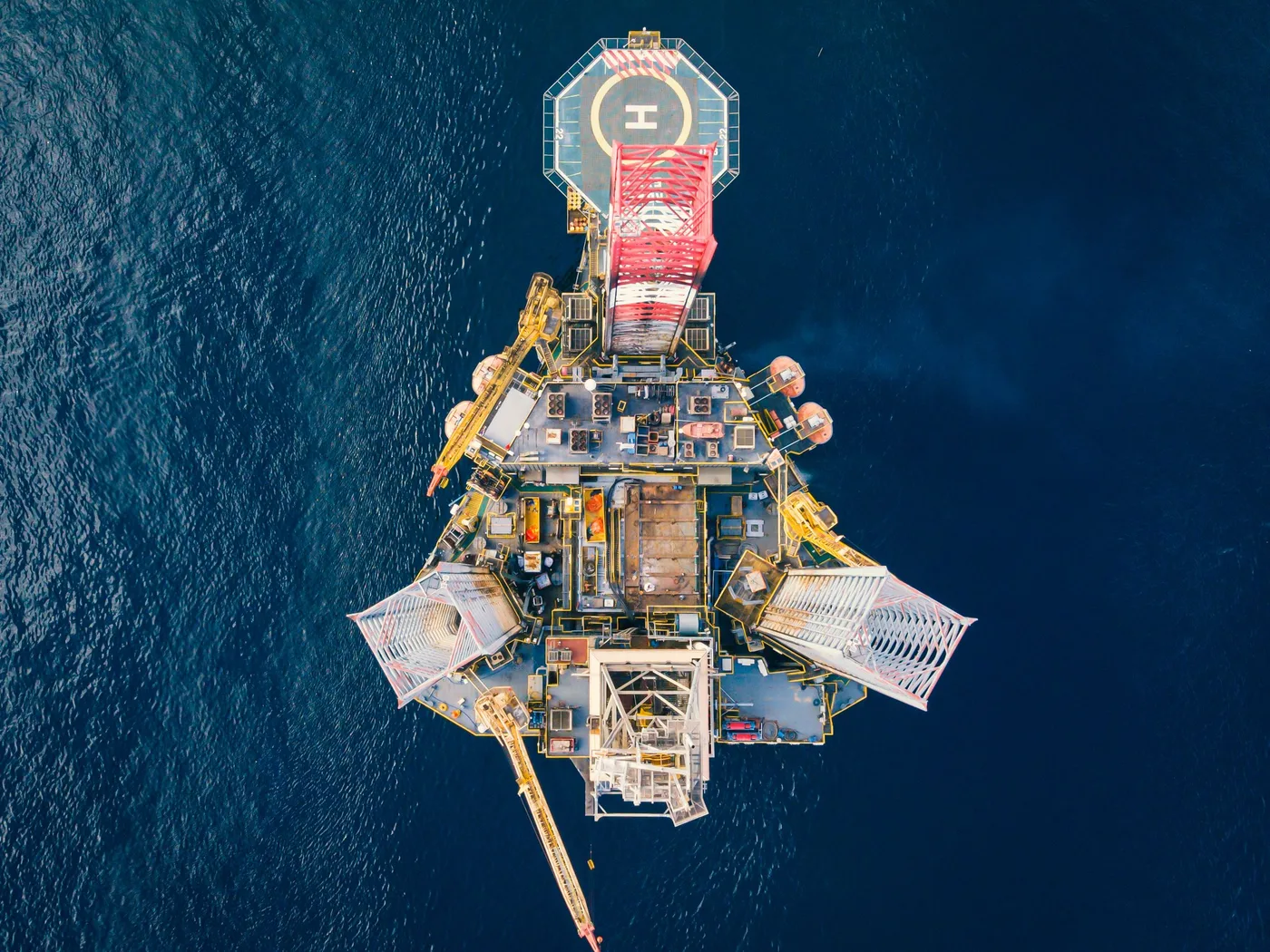 Aerial view of an offshore energy platform on open water